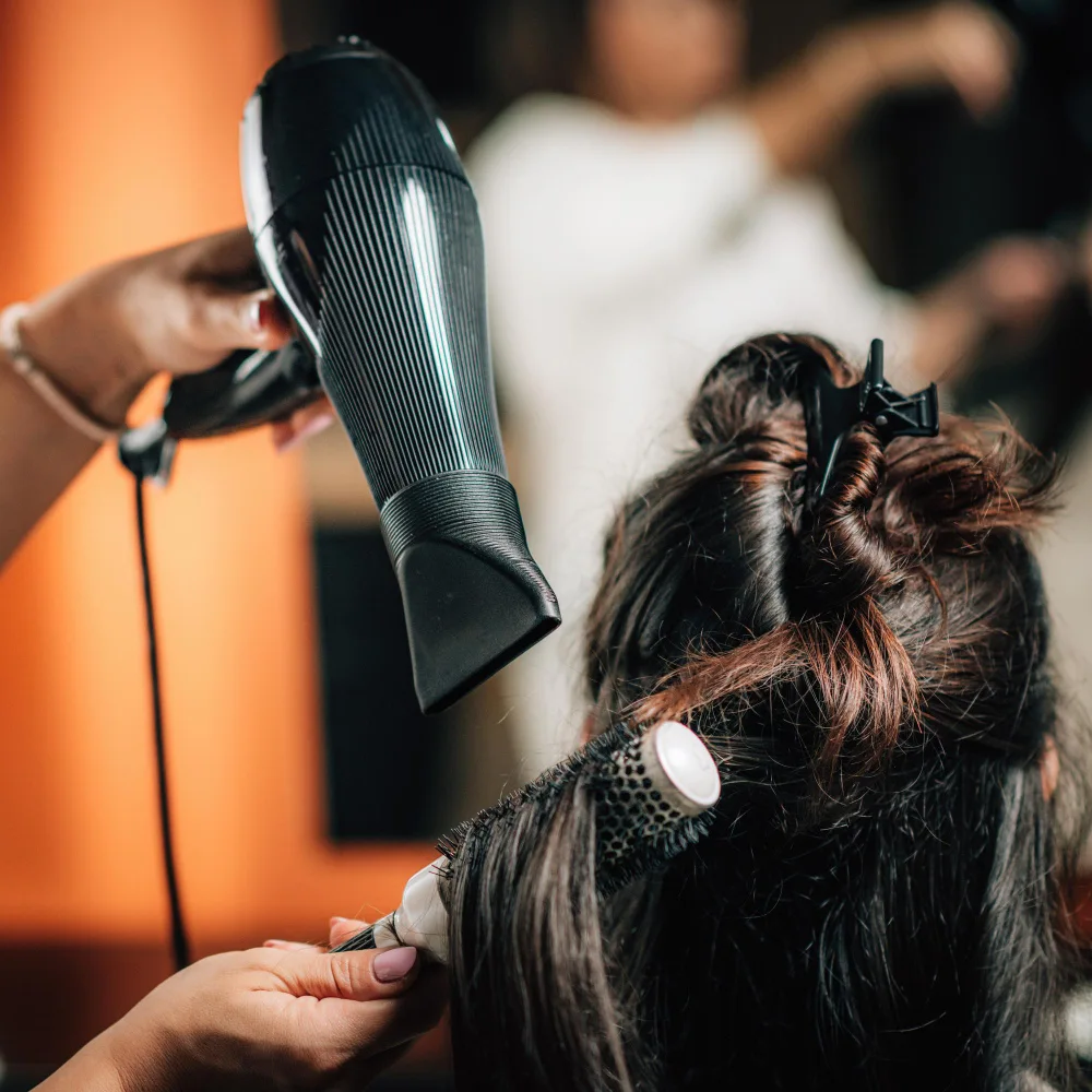 a person styling customer hair